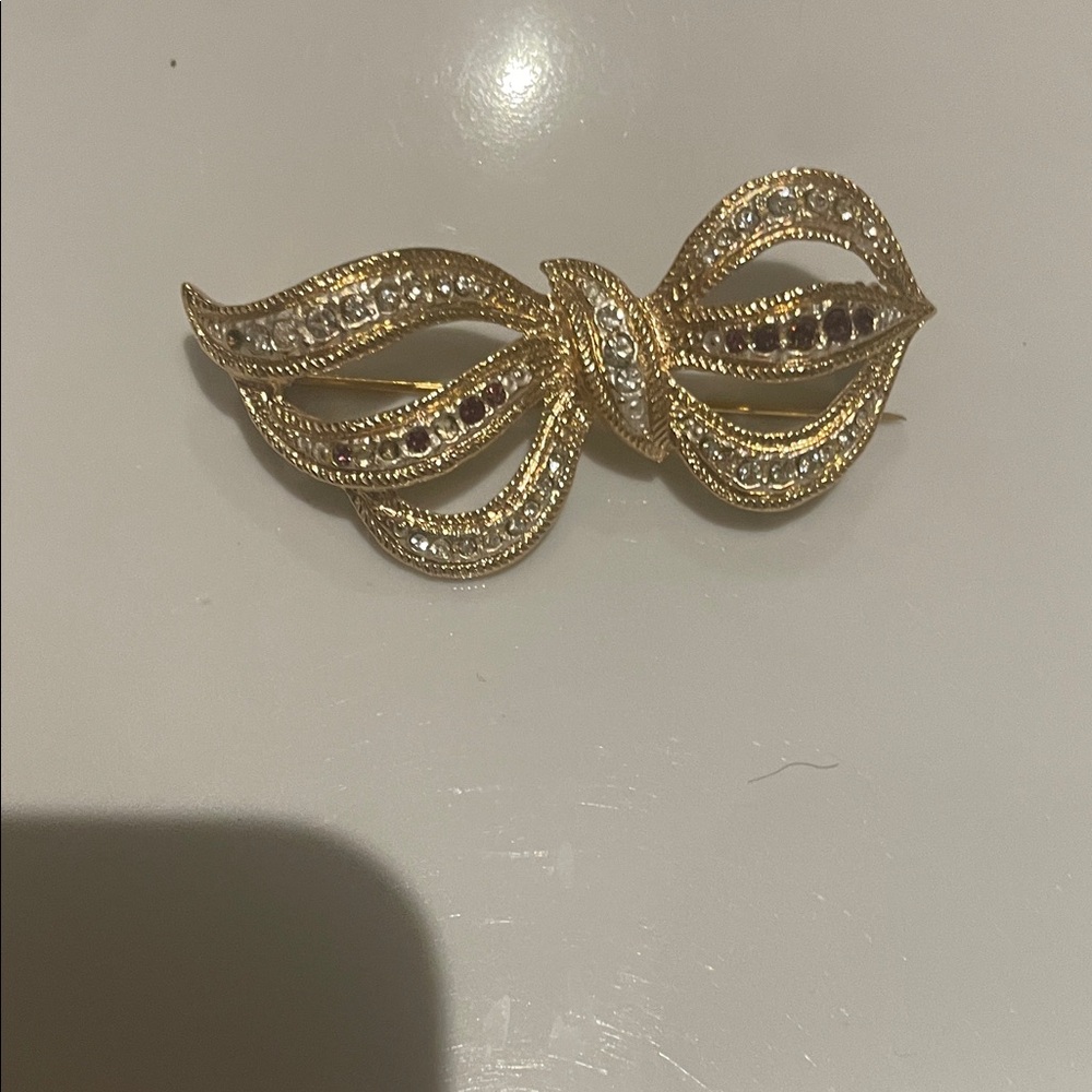 Gold-Tone Bow Brooch with Clear and Ruby-Like Stones